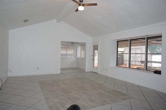 empty room with tile patterned floors, a healthy amount of sunlight, ceiling fan, and vaulted ceiling with beams