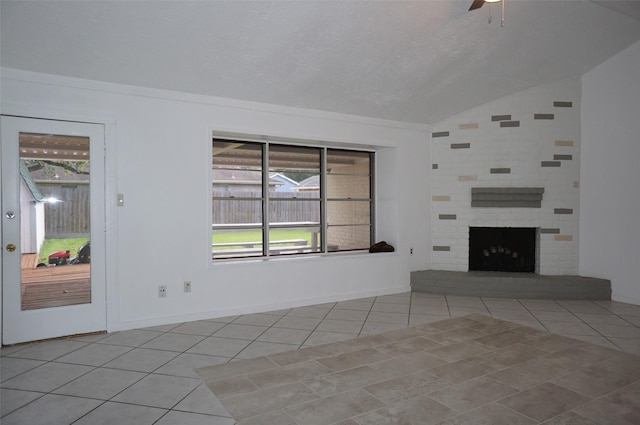 unfurnished living room with tile patterned floors, a ceiling fan, a fireplace, and vaulted ceiling