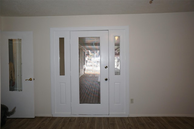 interior space with baseboards and dark wood-style flooring