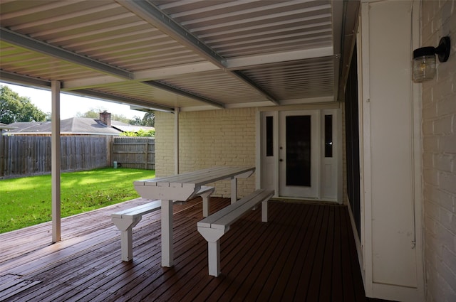 deck with a lawn and fence