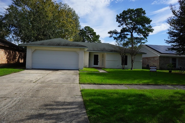 ranch-style home with brick siding, an attached garage, concrete driveway, and a front lawn