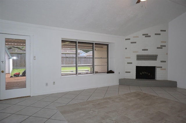 unfurnished living room with tile patterned floors, a fireplace, a ceiling fan, and vaulted ceiling