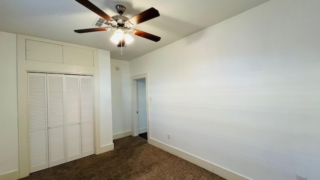 unfurnished bedroom featuring a ceiling fan, baseboards, a closet, and dark carpet