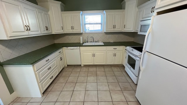 kitchen featuring a sink, dark countertops, tasteful backsplash, white cabinetry, and white appliances