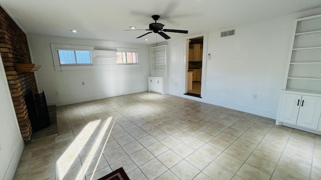 unfurnished living room featuring built in features, a ceiling fan, baseboards, light tile patterned floors, and a brick fireplace