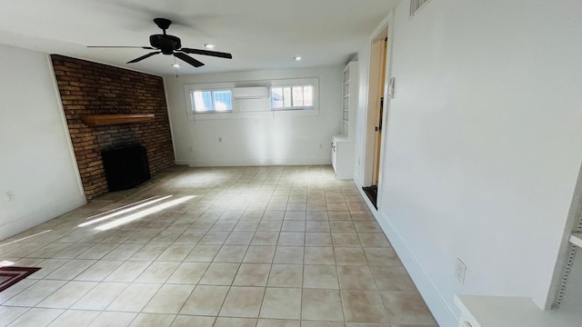 unfurnished living room with visible vents, a brick fireplace, ceiling fan, a wall mounted air conditioner, and light tile patterned floors