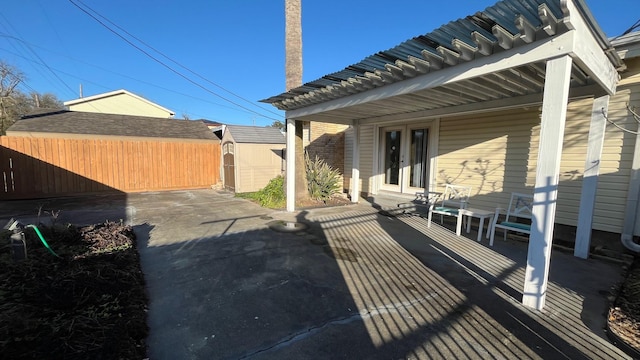 view of patio featuring french doors and fence