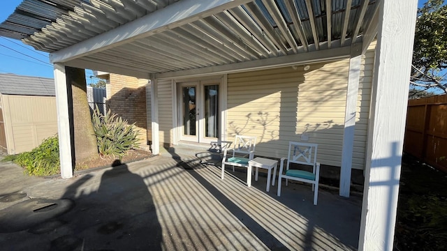 view of patio / terrace featuring french doors and fence