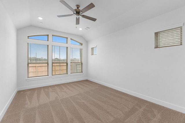 unfurnished room with baseboards, lofted ceiling, and carpet