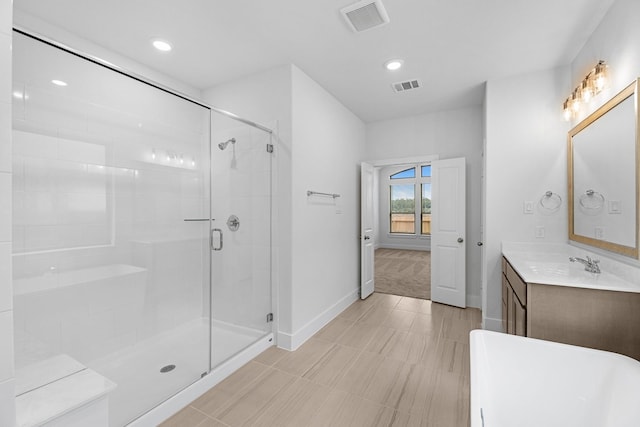 bathroom with visible vents, a stall shower, vanity, and baseboards