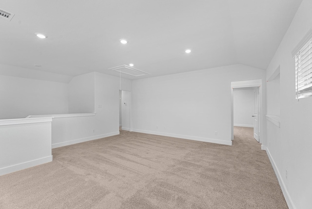 interior space featuring recessed lighting, light colored carpet, attic access, and lofted ceiling