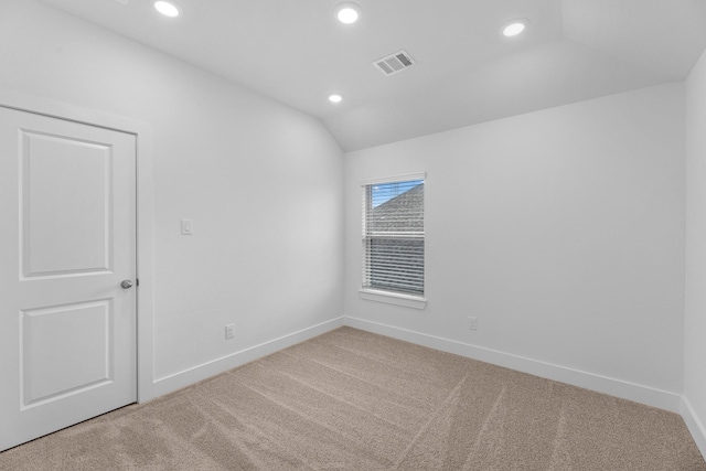 unfurnished room with visible vents, light carpet, recessed lighting, baseboards, and vaulted ceiling