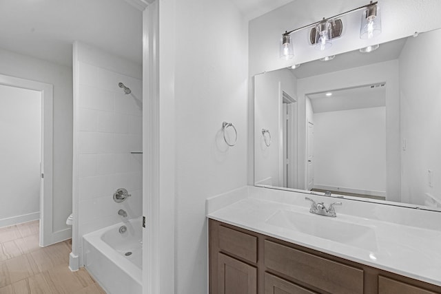 full bath featuring baseboards, toilet, vanity, and  shower combination