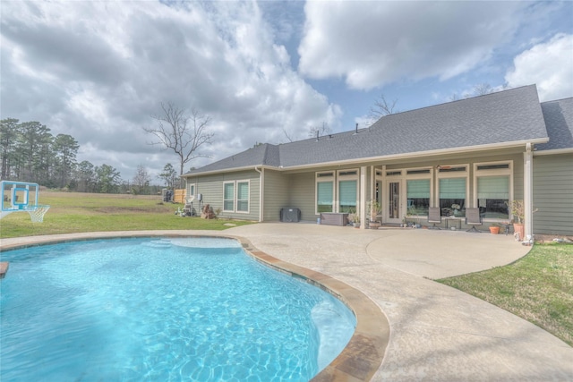 outdoor pool featuring a patio area and a yard