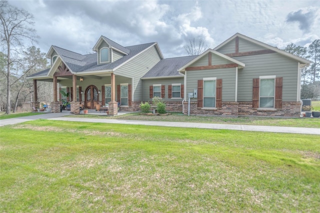 craftsman-style home with a front lawn and brick siding