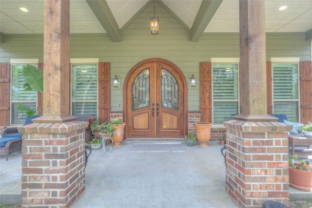 property entrance with a porch and french doors