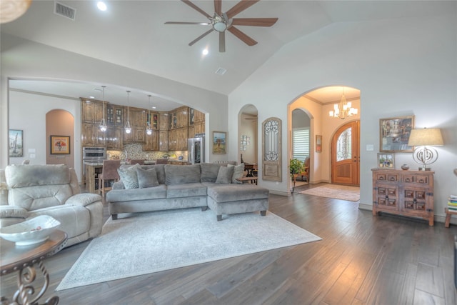 living area with visible vents, high vaulted ceiling, a ceiling fan, dark wood-style floors, and arched walkways