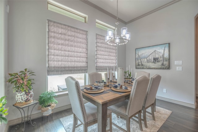 dining area with wood finished floors, baseboards, a chandelier, and ornamental molding