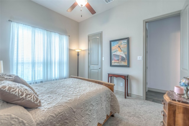 carpeted bedroom featuring baseboards and a ceiling fan