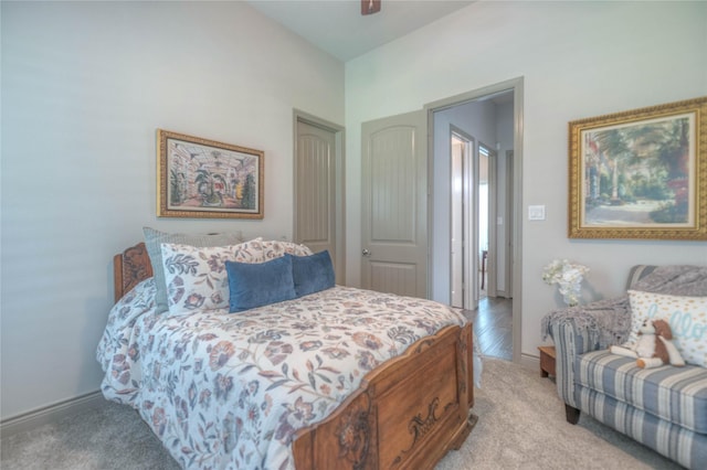 bedroom with light carpet, a ceiling fan, and baseboards