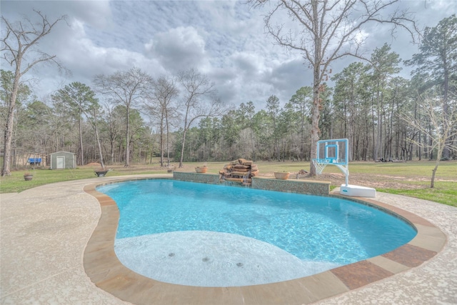 outdoor pool with a storage unit, a yard, and an outbuilding