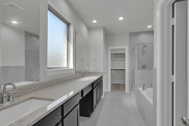 2512 Seneca Lake Dr, Texas City, TX 77568 - bathroom with a stall shower, a garden tub, a walk in closet, tile patterned floors, and double vanity