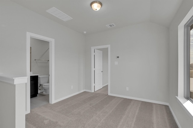 2512 Seneca Lake Dr, Texas City, TX 77568 - unfurnished bedroom featuring carpet floors, vaulted ceiling, baseboards, and ensuite bathroom
