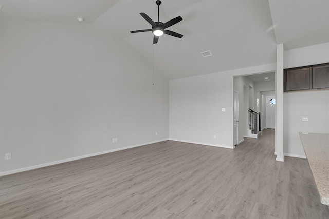 2512 Seneca Lake Dr, Texas City, TX 77568 - unfurnished living room with a ceiling fan, light wood-type flooring, stairway, baseboards, and high vaulted ceiling