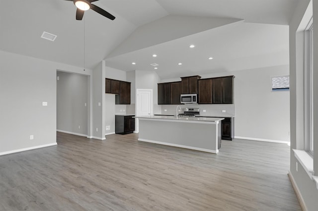 2512 Seneca Lake Dr, Texas City, TX 77568 - kitchen with appliances with stainless steel finishes, ceiling fan, open floor plan, light countertops, and high vaulted ceiling