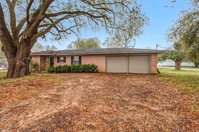 ranch-style home with brick siding, driveway, and an attached garage