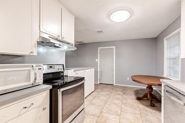 kitchen featuring white cabinetry, light countertops, under cabinet range hood, and stainless steel appliances