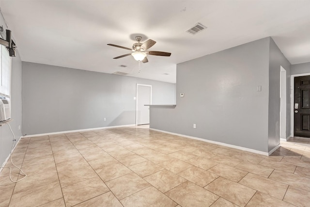 empty room with light tile patterned flooring, baseboards, visible vents, and ceiling fan