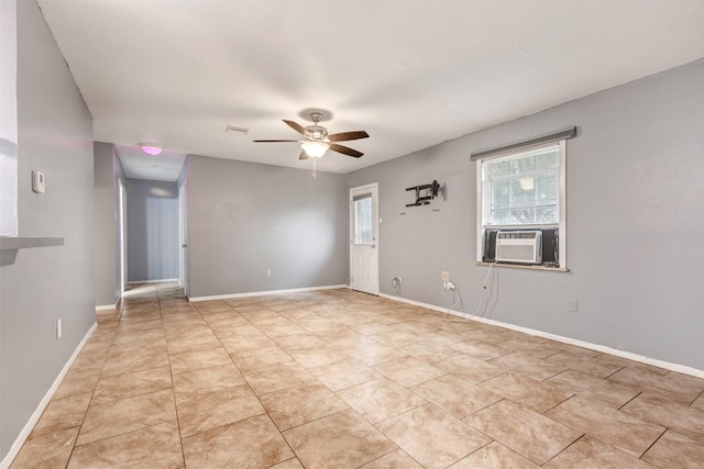 empty room featuring light tile patterned floors, visible vents, baseboards, and ceiling fan