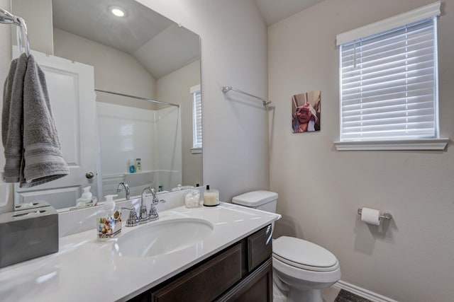 full bathroom with vanity, toilet, baseboards, and walk in shower