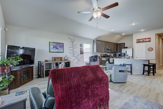 living area with vaulted ceiling, recessed lighting, light wood-type flooring, and ceiling fan