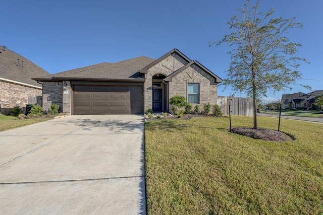 view of front of home featuring concrete driveway, brick siding, a garage, and a front yard