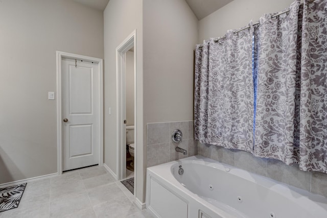full bath with tile patterned floors, toilet, baseboards, and a whirlpool tub