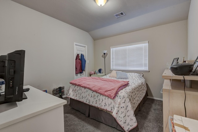 bedroom with visible vents, baseboards, carpet flooring, and vaulted ceiling