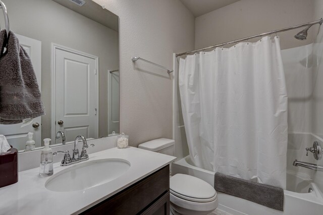 bathroom featuring visible vents, toilet, vanity, and shower / bathtub combination with curtain