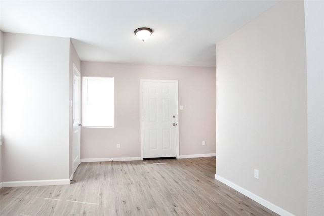 unfurnished room featuring baseboards and wood finished floors