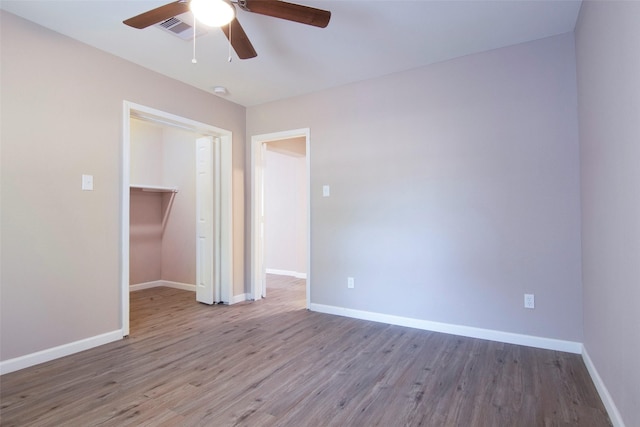 empty room featuring visible vents, baseboards, and wood finished floors