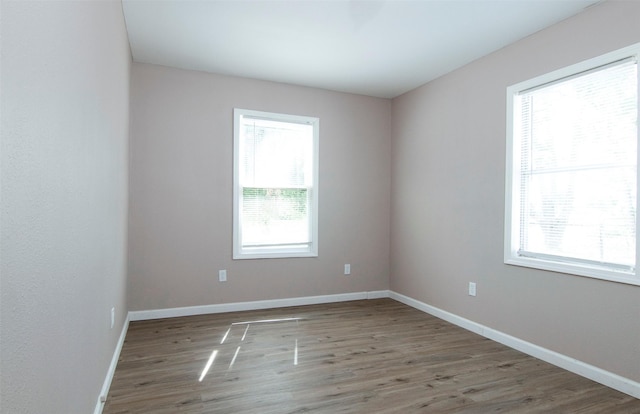 empty room featuring baseboards and wood finished floors