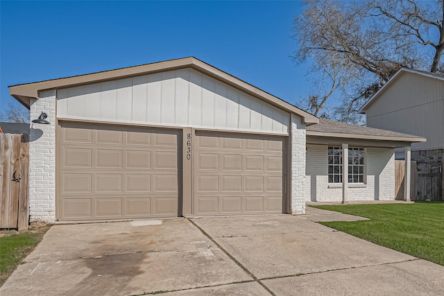 view of front of home with a front yard, fence, an attached garage, concrete driveway, and brick siding