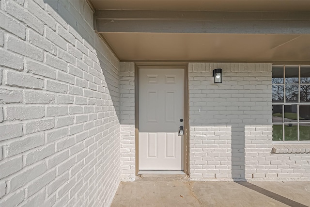 property entrance with brick siding