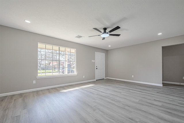 unfurnished room featuring visible vents, recessed lighting, baseboards, and wood finished floors