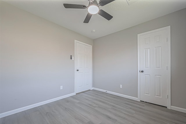 unfurnished bedroom featuring light wood-type flooring and baseboards