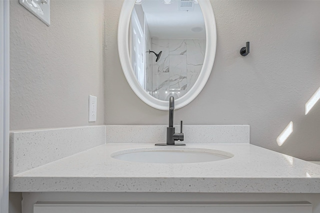 interior details with a shower and vanity