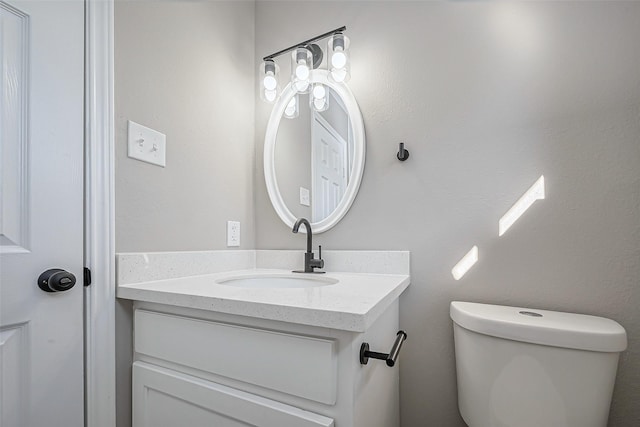 bathroom with toilet and vanity