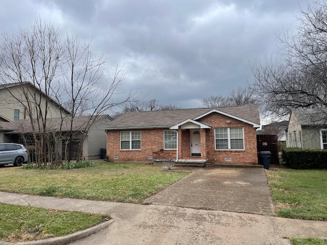 bungalow-style house with crawl space, a front yard, brick siding, and a shingled roof