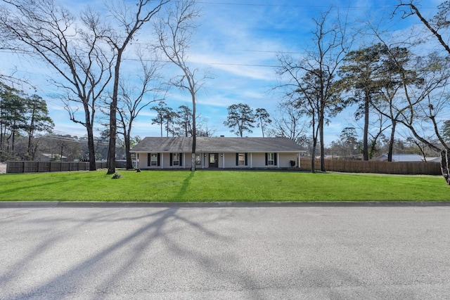 view of front of property with a front yard and fence